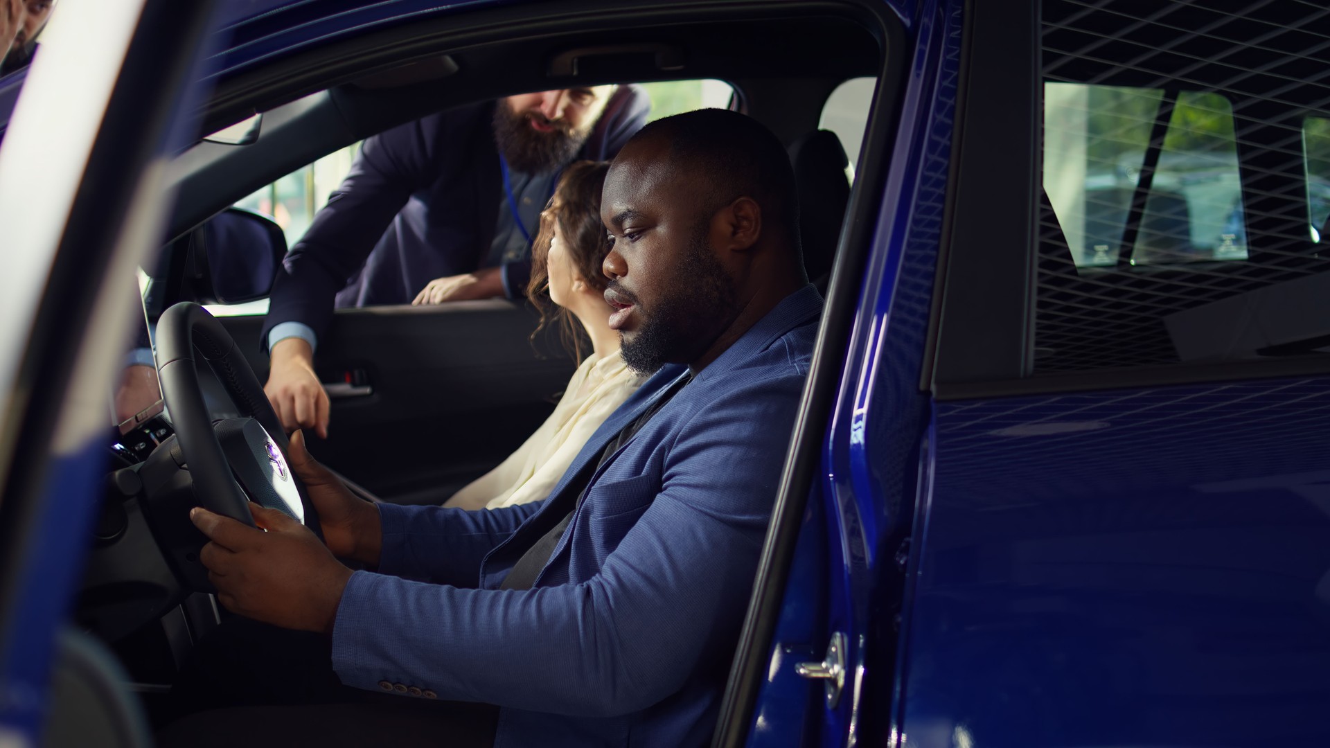 Husband and wife purchasing new vehicle, evaluating how it feels